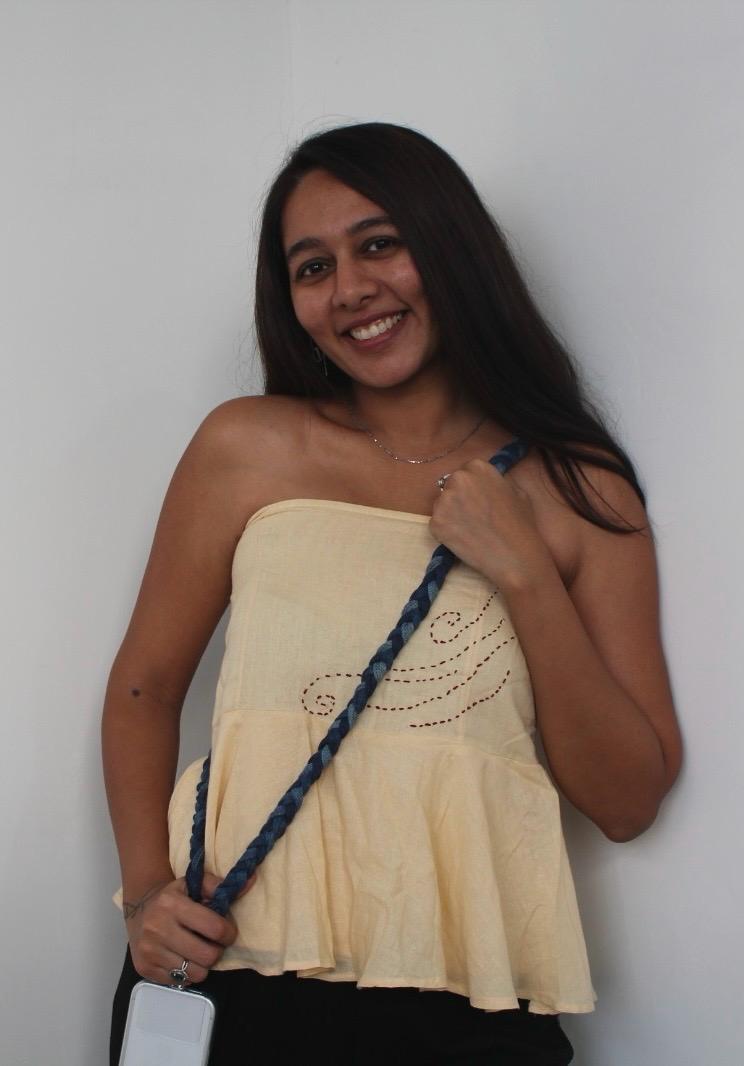 Woman styling JOD's denim braided phone sling lanyard crossbody, worn over a cream cotton tube top with hand-stitched detailing