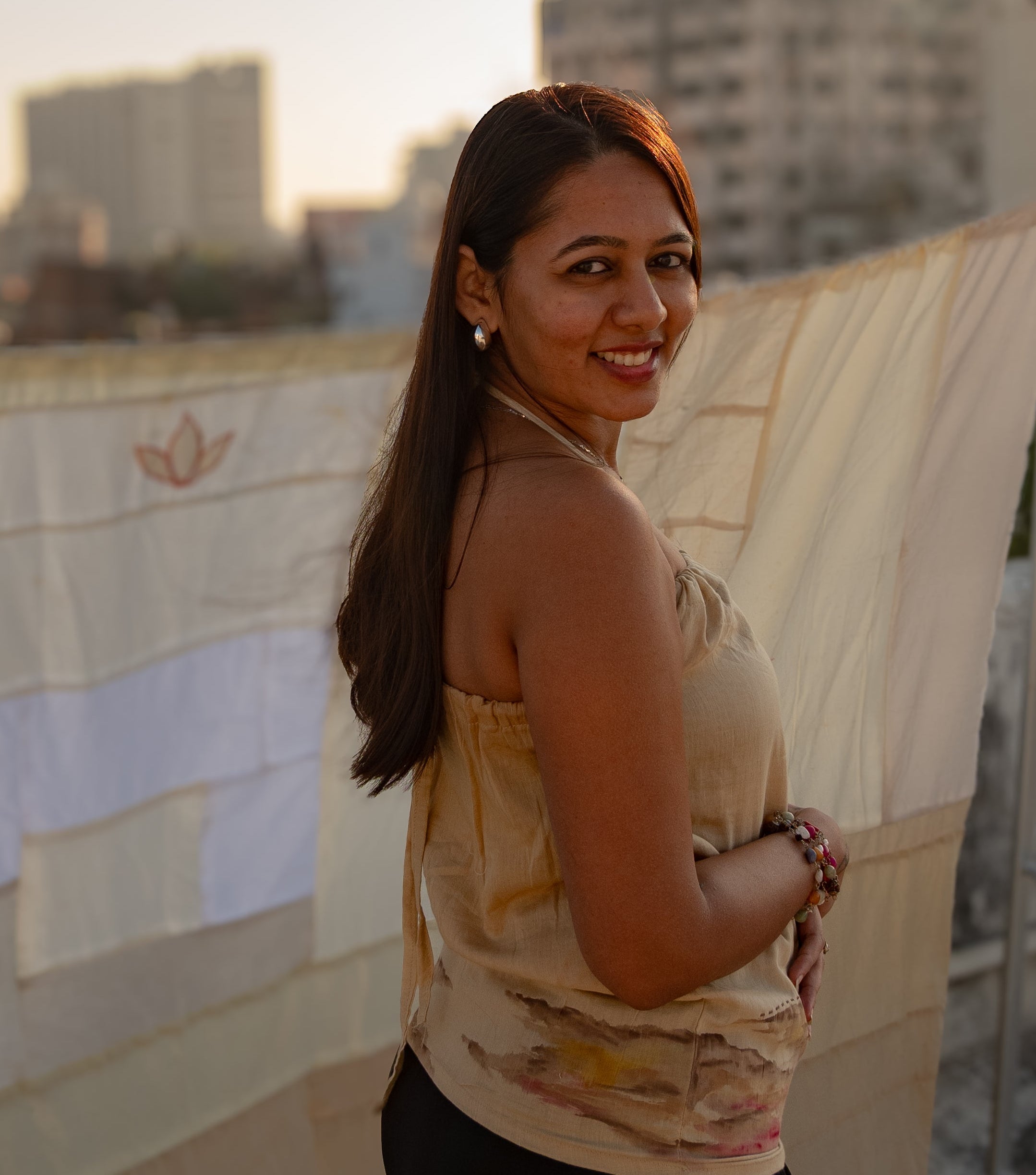 Beige sleeveless cotton summer top with subtle abstract artwork, comfortable top for casual outings and vacations.
