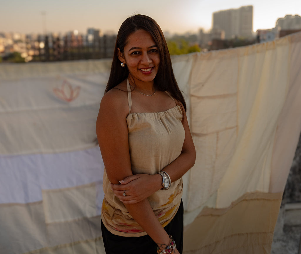 Beige sleeveless cotton top with abstract design accents, breathable summer top styled for casual daywear.