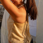 Beige sleeveless cotton top styled for summer outings and vacations, lightweight casual wear.