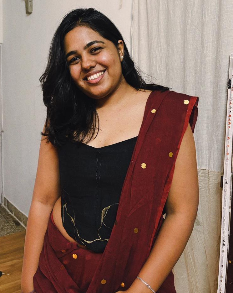 Black strapless corset blouse with gold detailing, styled as a saree blouse or party corset top for festive occasions.