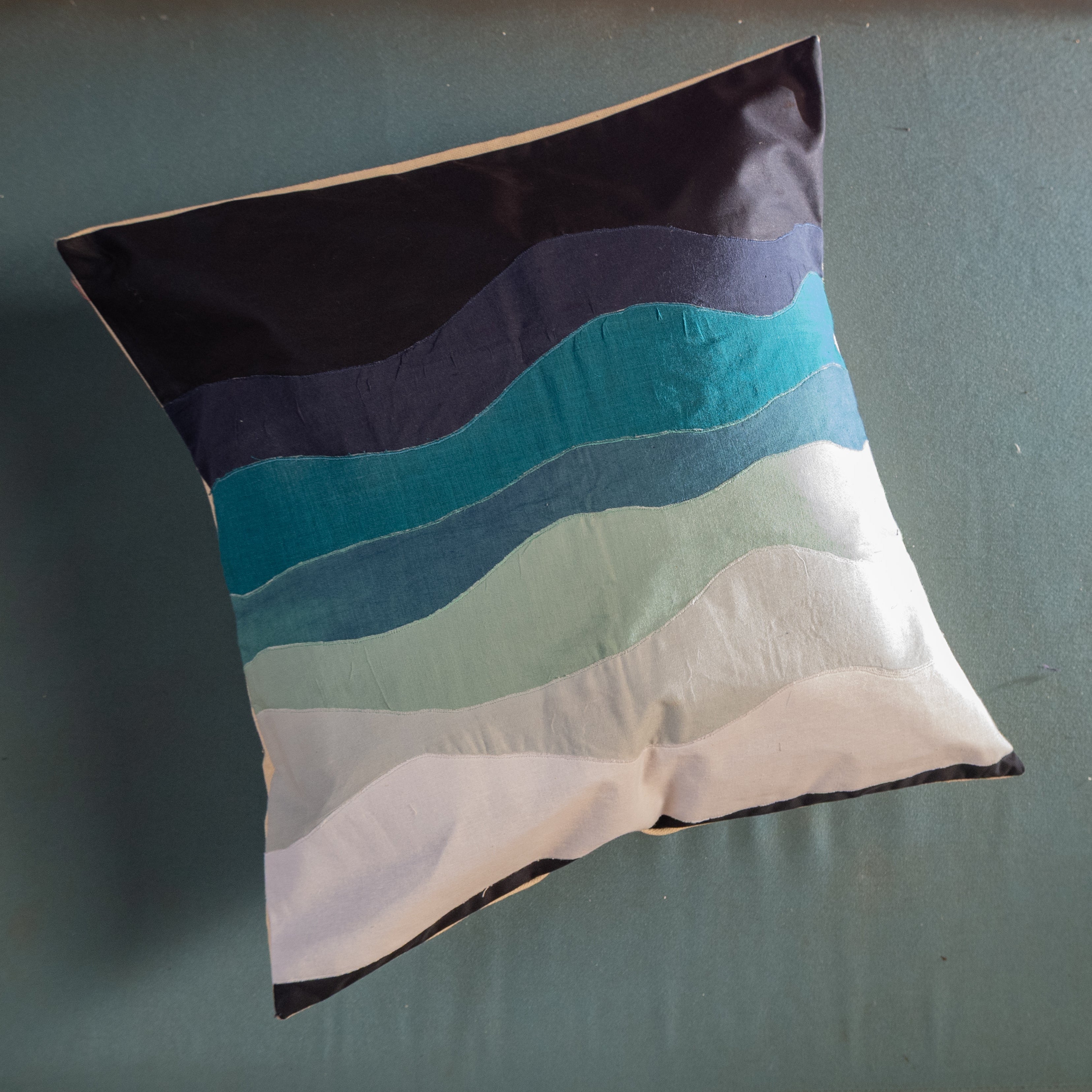 Colorful striped pillow on a plain background