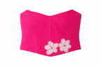 Pink corset top with floral embellishments on a white background