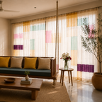 Living room with a wooden sofa, coffee table, and colorful patched semi sheer curtains.