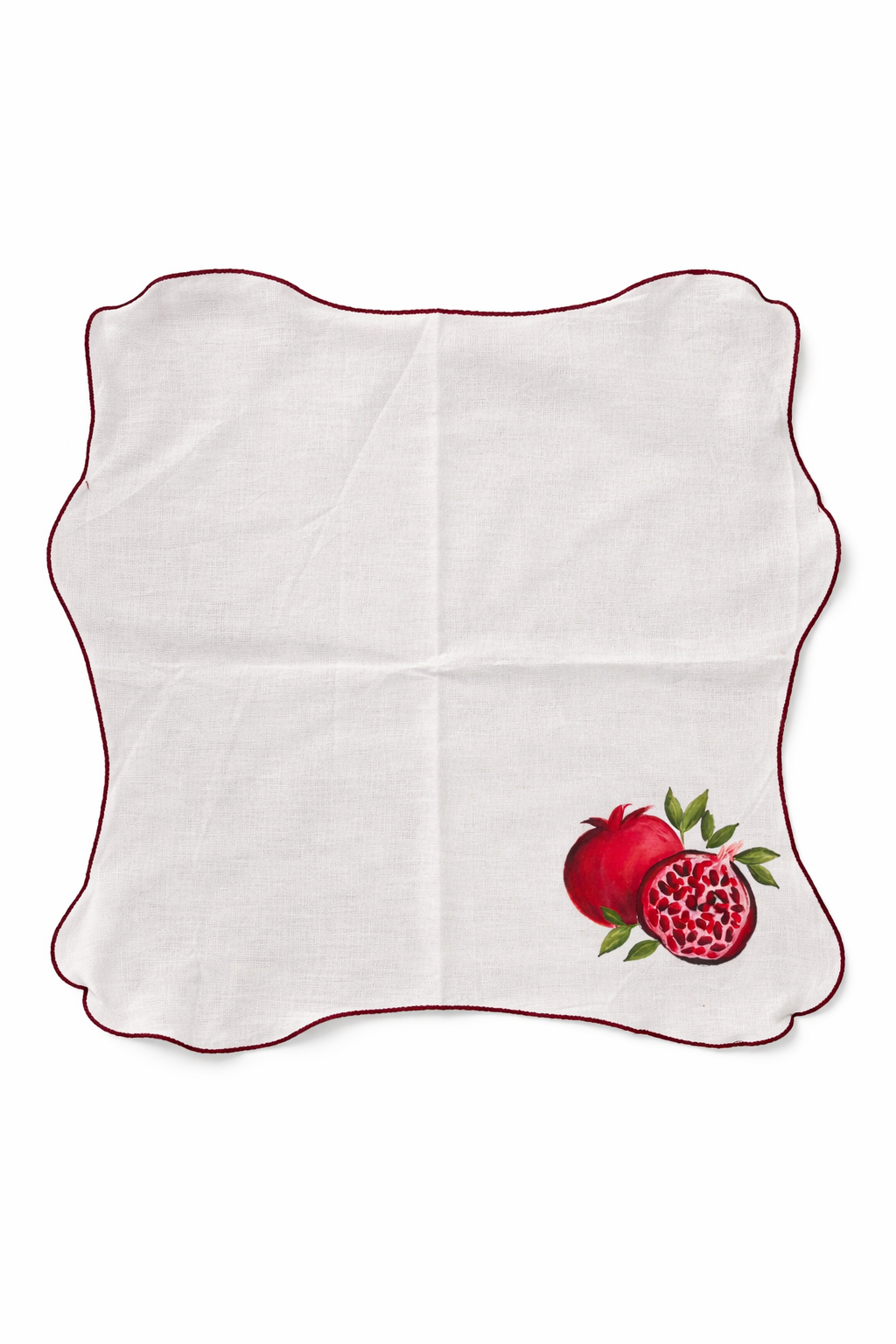 White napkin with red pomegranate design on a white background