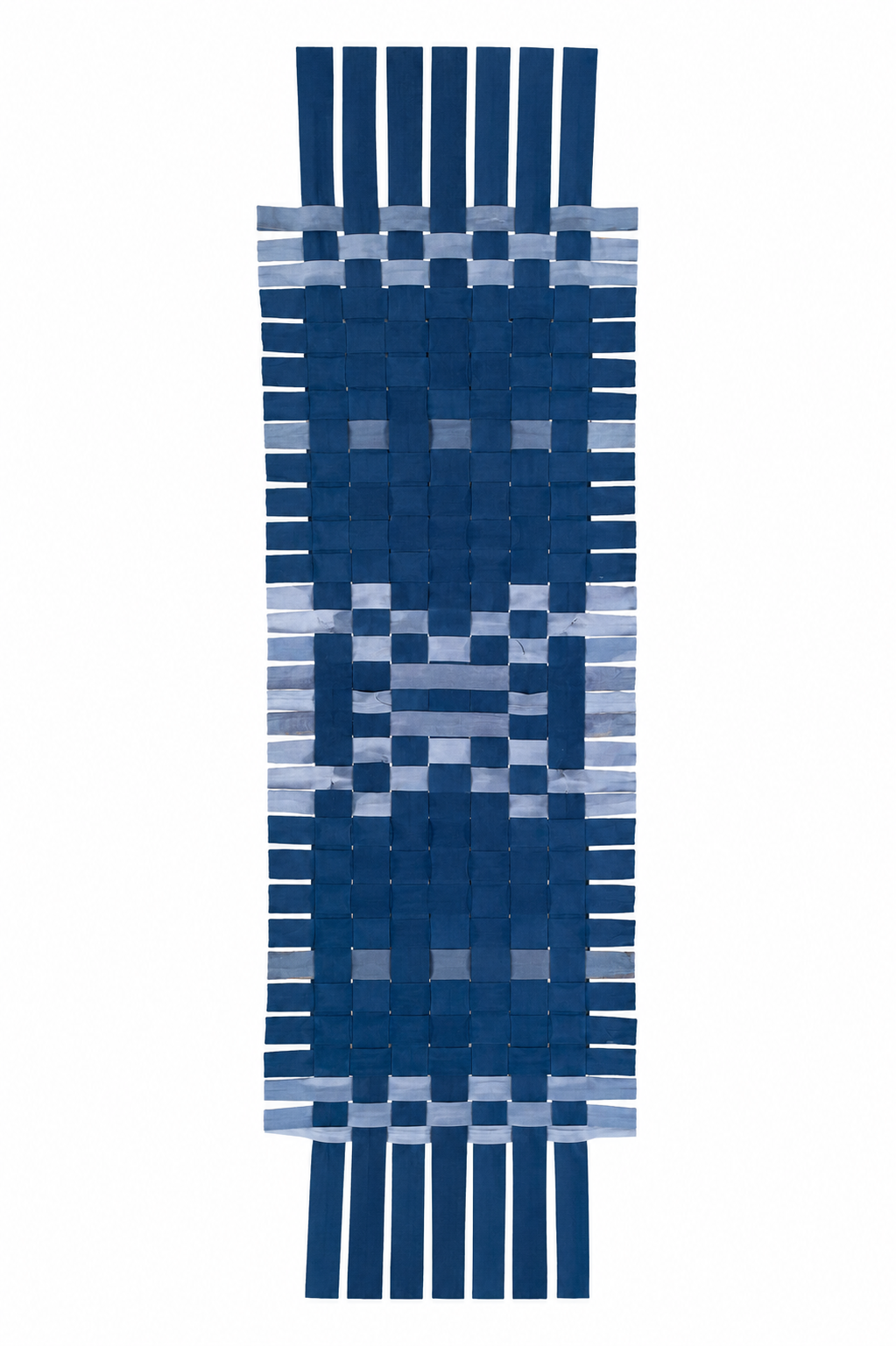 A woven rectangular textle with fringe ends, featuring a geometric pattern in shades of navy blue, medium blue, and light blue on a white background.