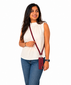 Woman holding a red crossbody bag against a white background