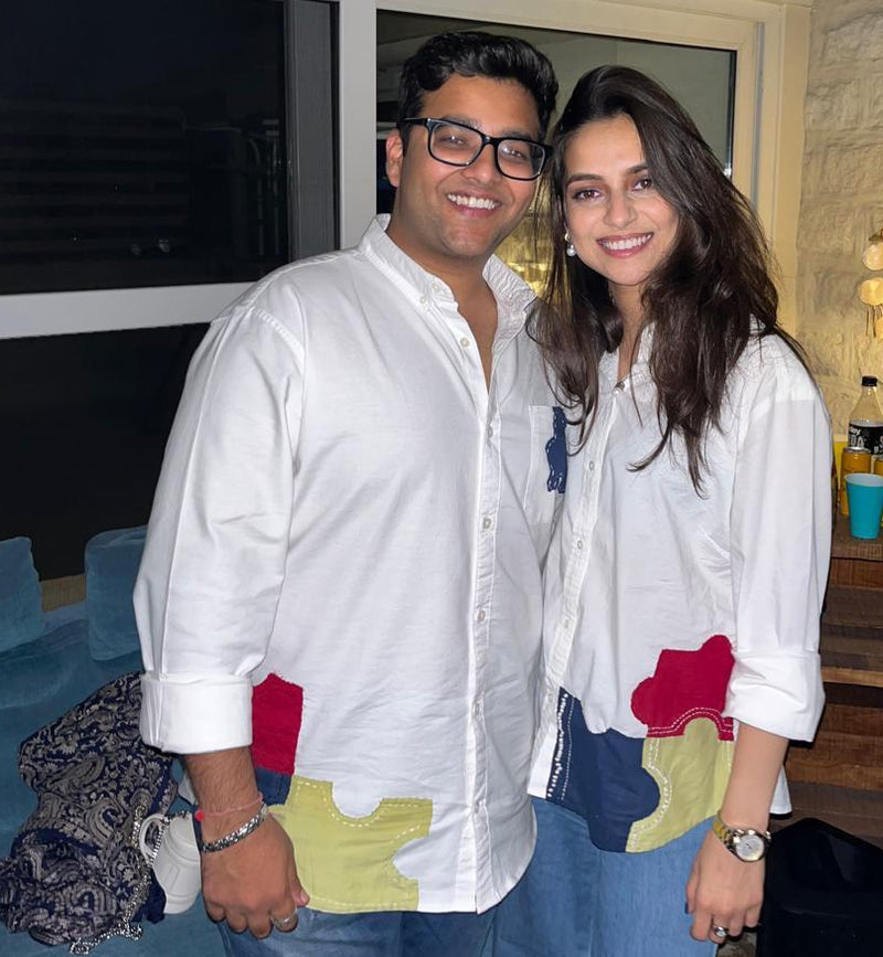 Two people wearing custom couple shirts at a party