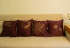 Beige sofa with decorative hand painted pillows and a small table