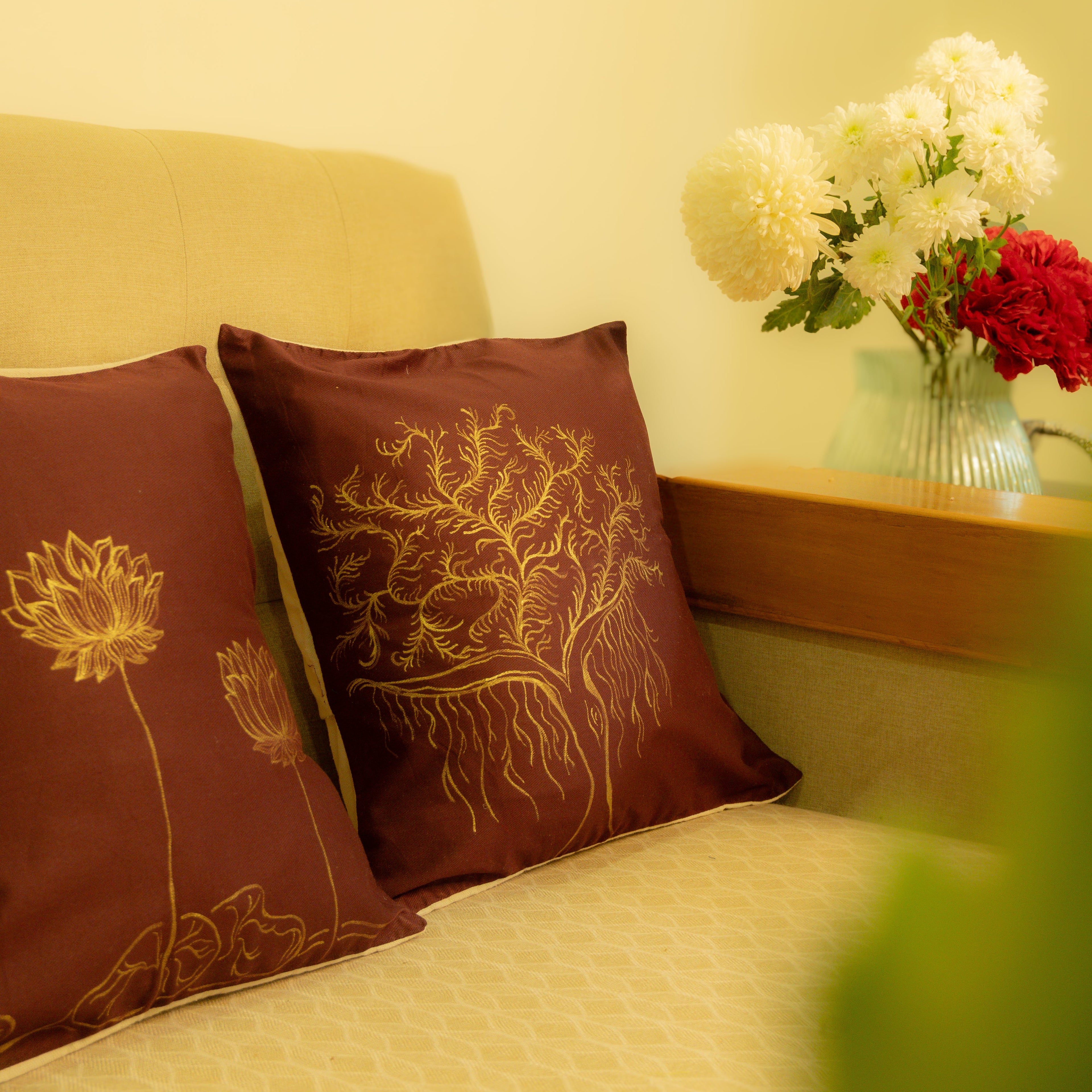 Maroon cotton cushion covers with hand painted artwork motifs, decorative throw pillow covers for sofa and living room styling.
