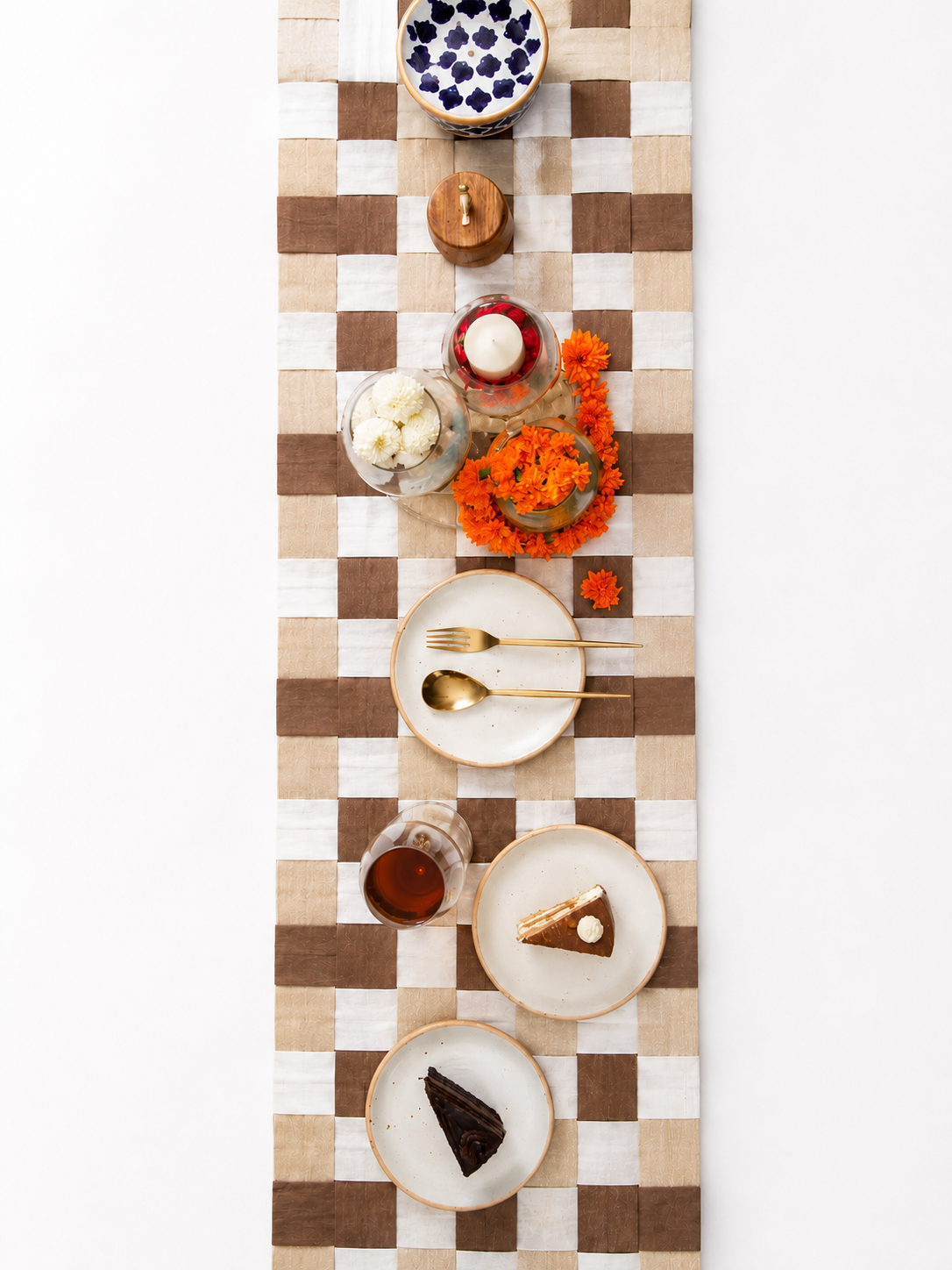 Chexed table runner with a tabke setting of brunch with white plates and pastry
