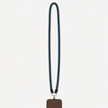A dark brown leather phone case with a matching dark blue denim braided lanyard strap, shown against a light gray background.
