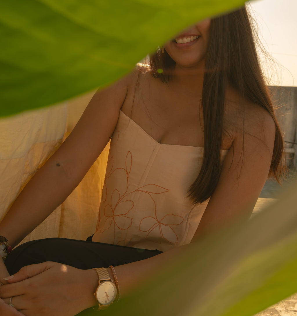 Peach corset with delicate floral embroidery, styled as a modern saree blouse or summer party corset top.