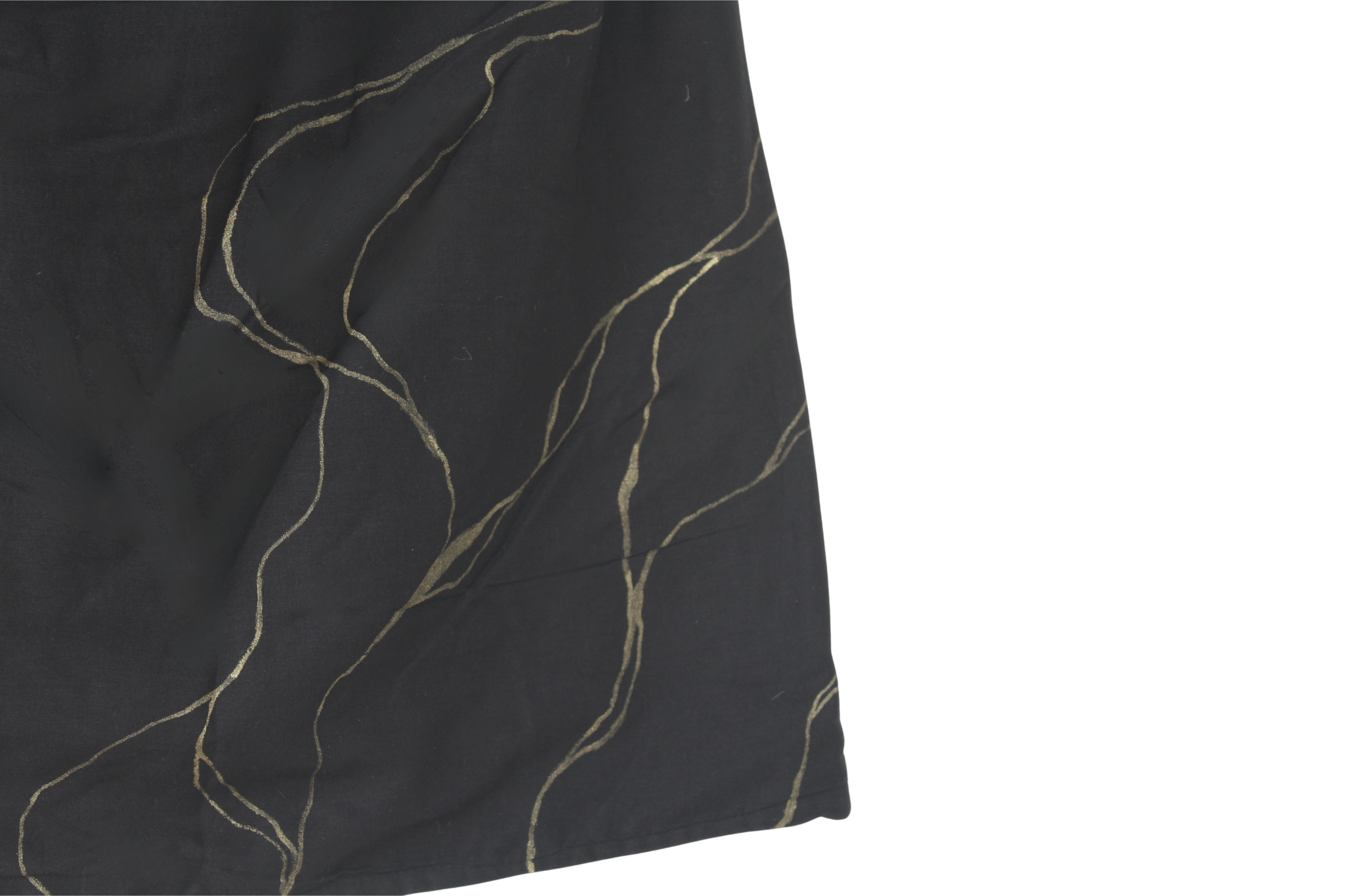 Close-up of a black top with gold thread patterns with golden