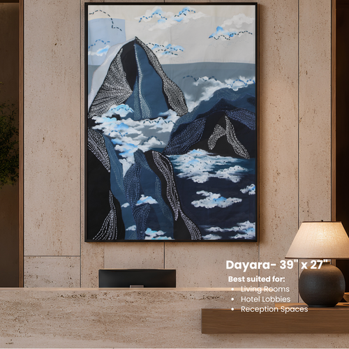Framed artwork of mountains and clouds on a wall in a modern interior setting.