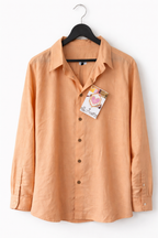 Orange shirt on a hanger with a tag on a white background