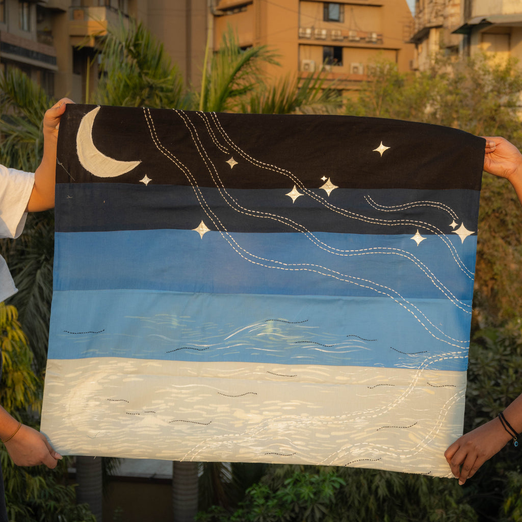 Person holding a starry night sky tapestry