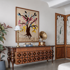 Decorative room with wooden dresser, wall art, and decorative items.