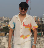 Relaxed fit men’s beach vacation shirt with hand painted colors, breathable summer shirt ideal for travel and holiday wear.