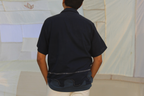 Person wearing pure cotton vacation shirt with relaxed fit and minimal design, breathable summer shirt ideal for travel and holiday outfits.