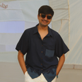 Man wearing a pure cotton relaxed fit summer shirt for men, lightweight breathable casual shirt perfect for vacations and warm weather.