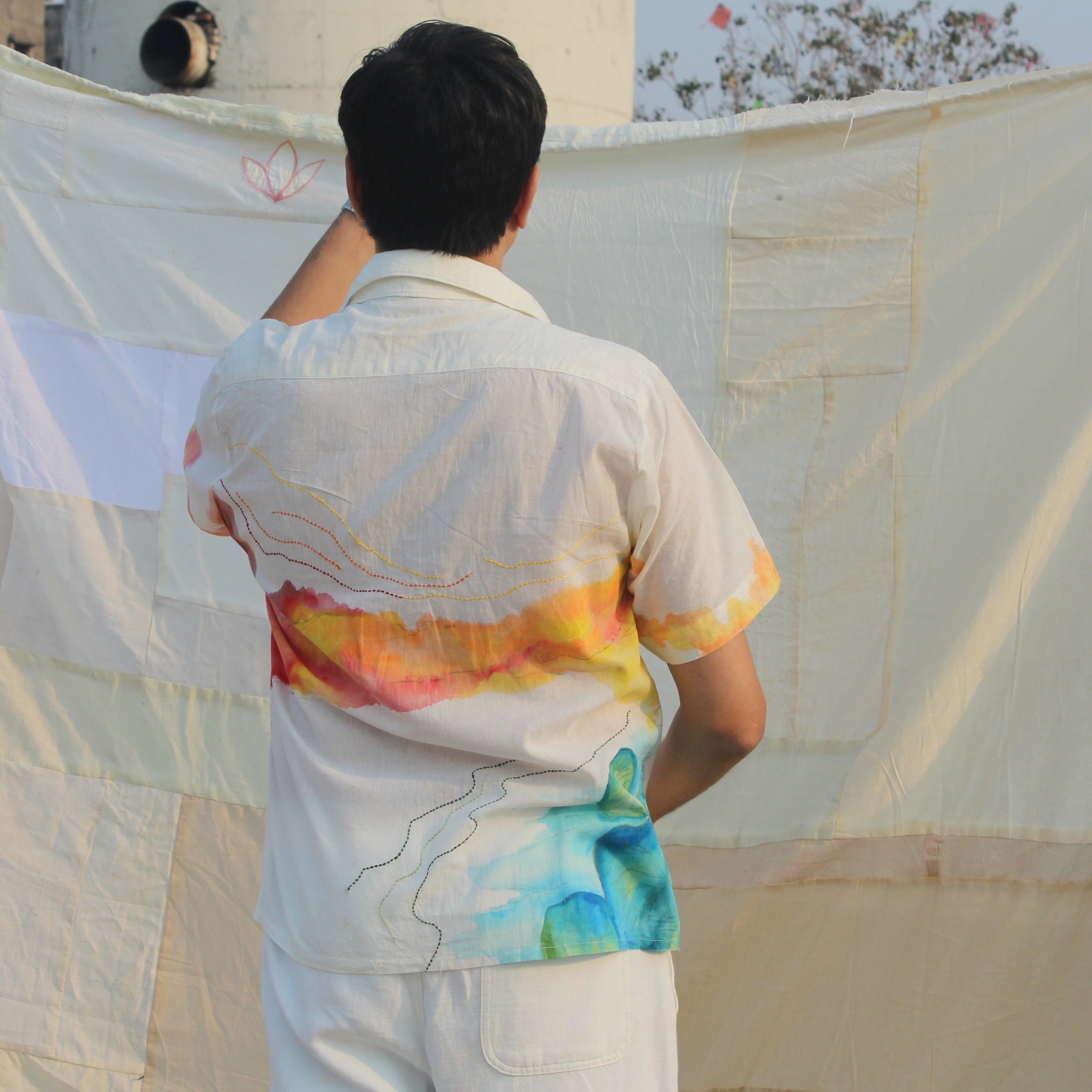 Men wearing a lightweight hand painted vacation shirt for summer, relaxed fit beach shirt for men with artistic color details.