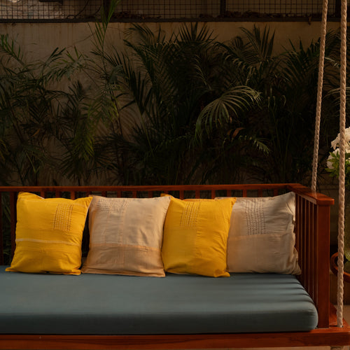 Wooden swing with minimal stitched texture cotton cushion covers 