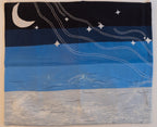 Fabric art piece with a night sky design featuring stars and a moon, hanging on a wall.