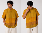 A man modeling a mustard yellow short-sleeve button-up shirt with horizontal patchwork panels and white embroidered details, shown in a side-by-side front and back view against a light gray studio background.