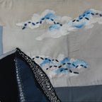 Handmade textile wall art featuring mountain landscape and clouds in deep blue tones, decorative wall art for living rooms, studios and modern interiors.