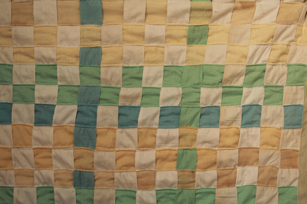 Woven curtain quilt with a grid of squares in various colors