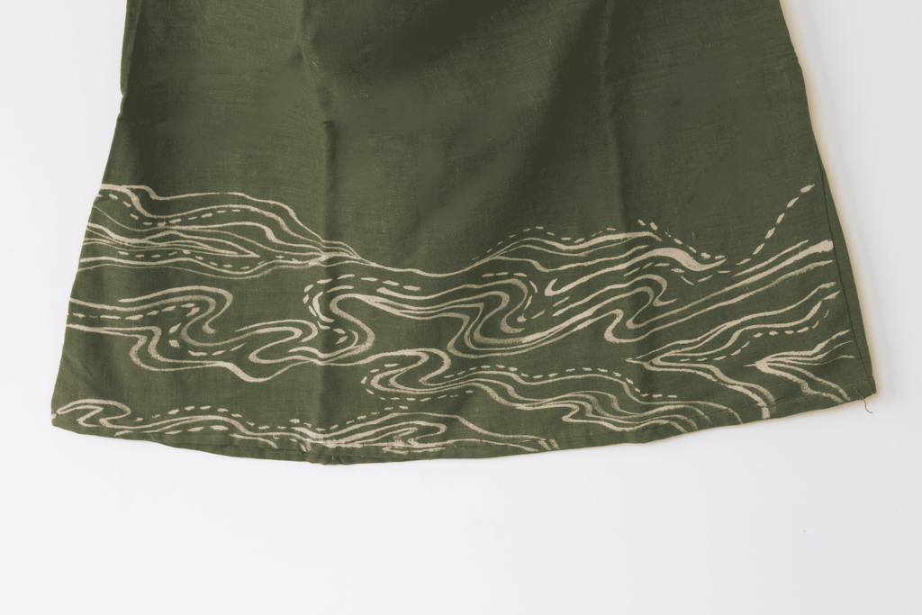 Green fabric with wavy white pattern 