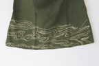 Green fabric with wavy white pattern 