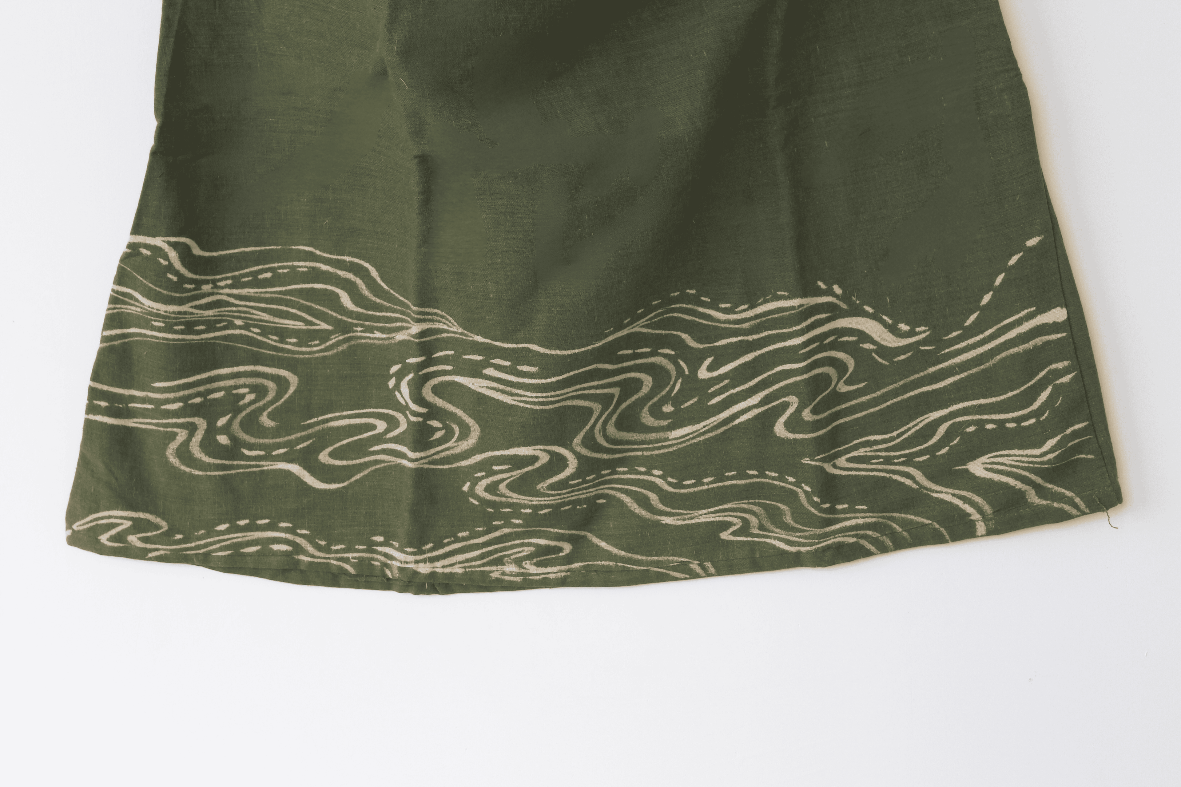 Green fabric with wavy white pattern 