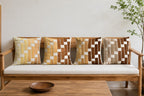 Wooden sofa with patterned cushions in a minimalistic room.