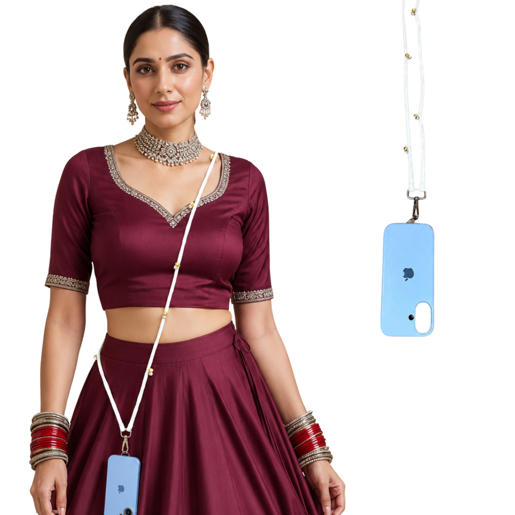 A woman models a deep maroon two-piece outfit with a matching skirt and blouse, featuring silver embellished borders on the neckline and sleeve cuffs. She is accessorized with a silver necklace, bangles, and earrings, and a light blue phone case with a white lanyard is shown on the right against a plain white background.