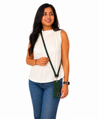 Woman holding a green crossbody bag against a white background