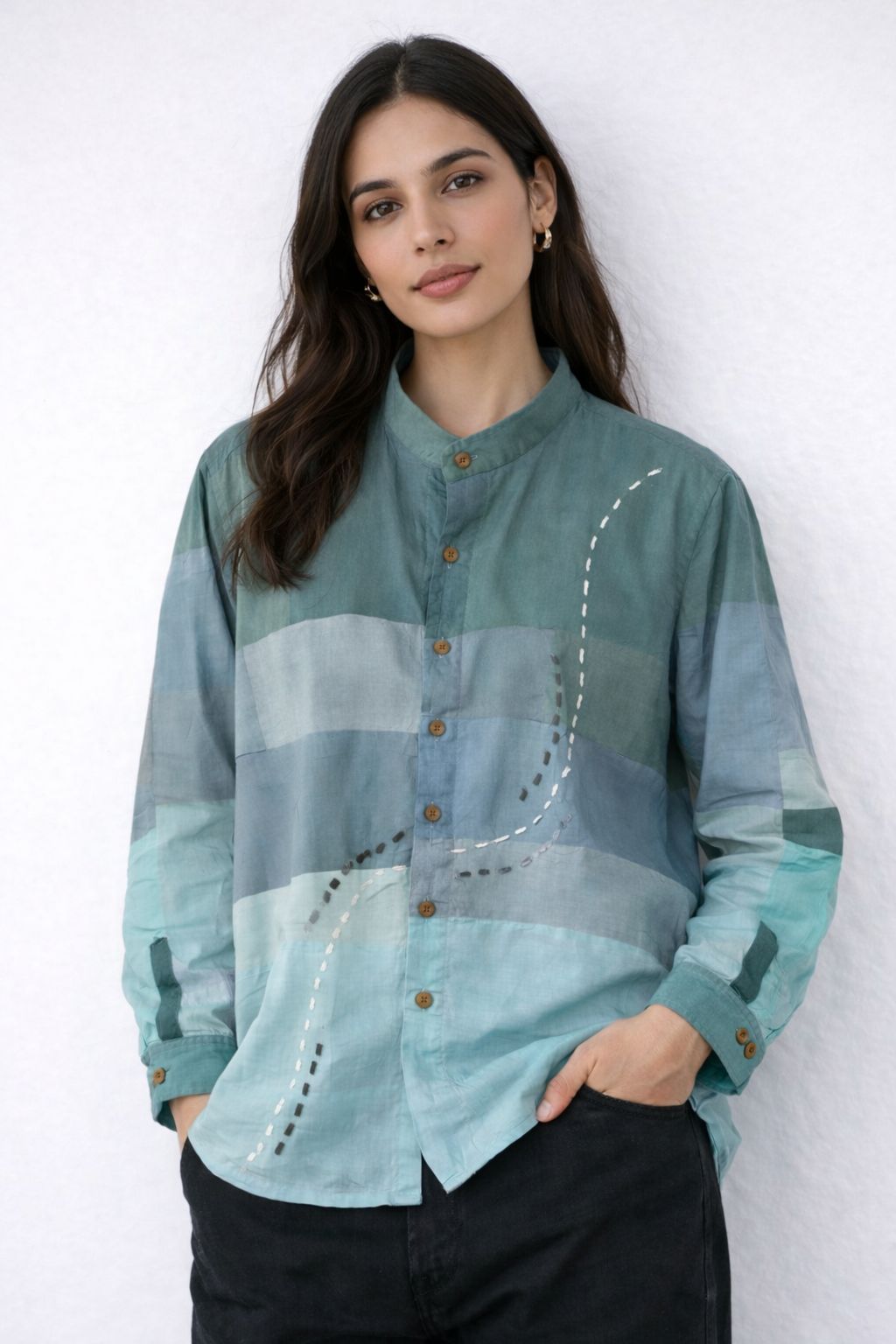 Woman wearing a teal colour patched shirt with hand embroidered details