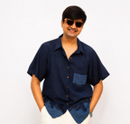 Man wearing a navy blue shirt with a pocket on a white background