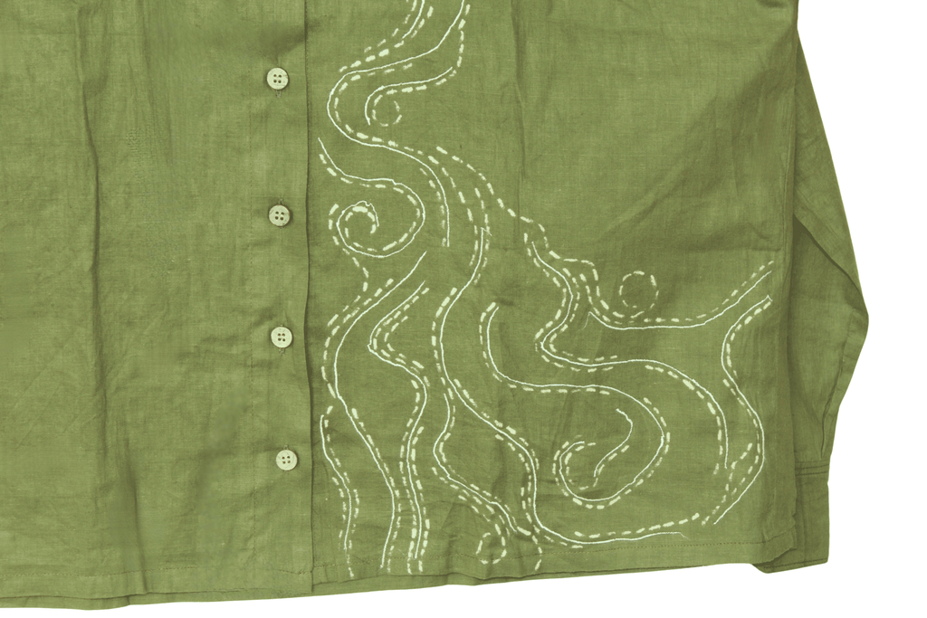 Green shirt with white embroidery on a white background