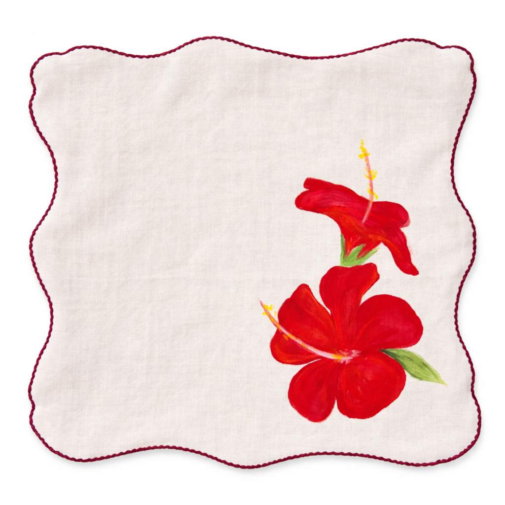 Reusable cotton table napkins with hand painted floral illustrations in orange, white and red tones, decorative cloth napkins for dining table styling.