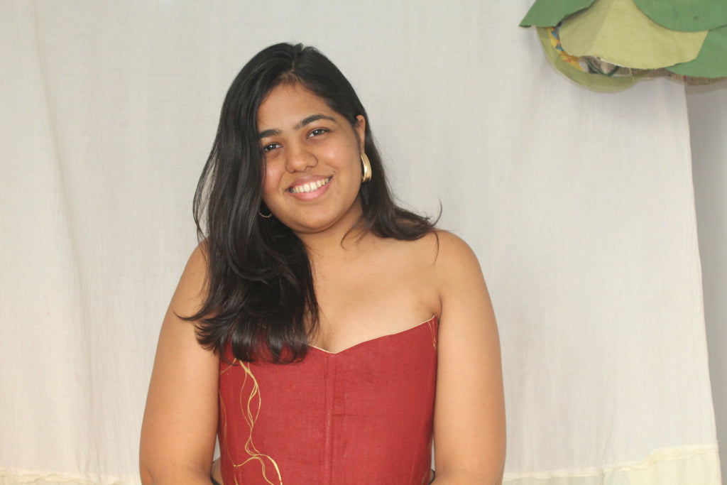 Strapless rust red corset top with gold detail design, stylish party corset blouse for festive occasions and saree looks.