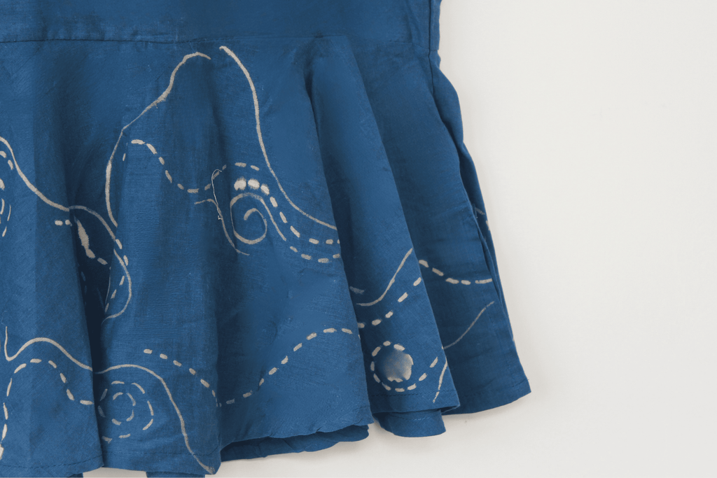 Blue cotton halter summer top inspired by the flowing movement of starry night, featuring stitched swirl detailing and a relaxed silhouette for warm weather outfits.