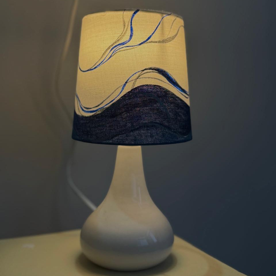 Lamp with a decorative shade on a plain background