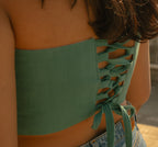 Teal strapless corset with white floral motif, stylish party corset top for evening events and celebrations.