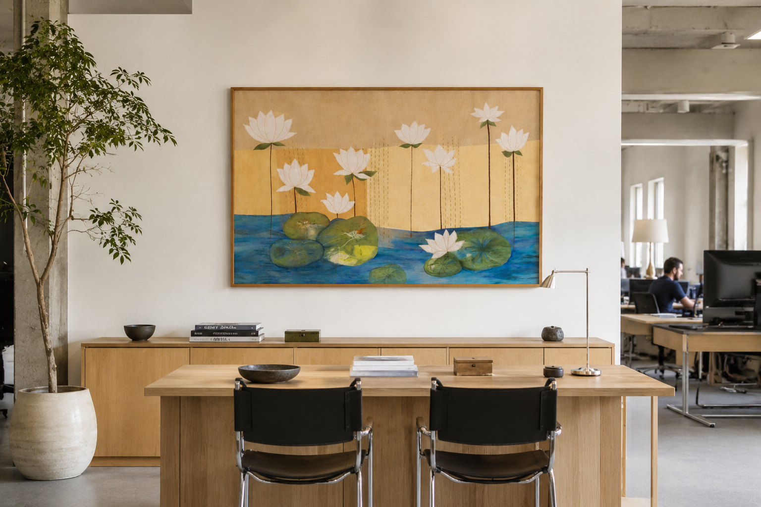 Modern office interior with a desk, chairs, and a wall painting of water lilies.