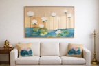 Sofa with floral cushions and a wall painting of water lilies in a living room.