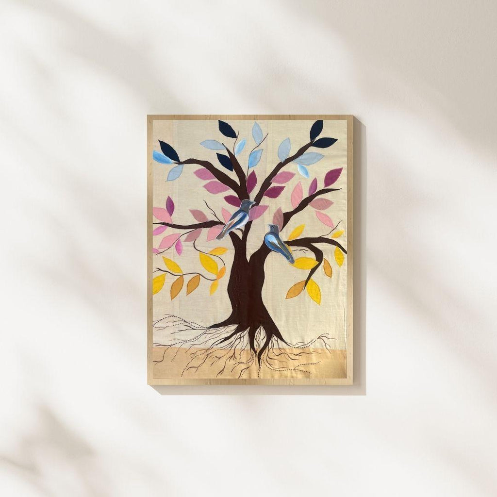 Tree of life textile wall art featuring colorful leaves and birds on a handcrafted fabric background, statement handmade wall art for living rooms, offices and modern interiors.