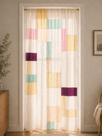 Sheer curtain with colorful geometric pattern in a room setting