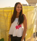 Woman wearing a cotton floral tube top with minimal flower detail, breathable strapless summer top for everyday outfits.